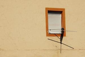 Window on the yellow facade of the house, architecture in Bilbao city, Spain photo