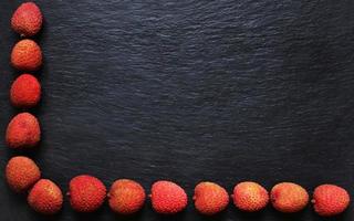 Litchis on slate background for menus, labels, or signs photo