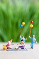 Miniature people, a beautiful couple of lesbian ladies having fun in the park with children photo