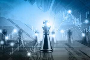 Double exposure of financial market stock chart with chess board game competition, success and leadership business concept photo