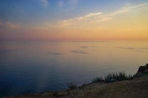 Colorful cloudy sunset over a body of water photo