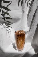 Close-up glass of iced coffee with milk on the table photo