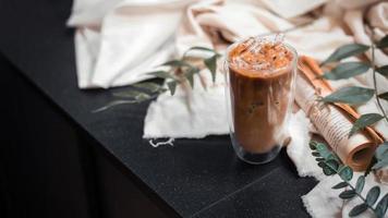 Close-up glass of iced coffee with milk on the table photo