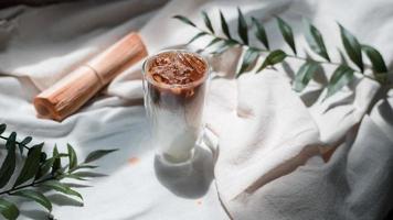 Close-up glass of iced coffee with milk on the table photo