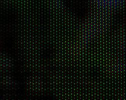 Abstract background pattern of colored blurry dots on a dark background close up photo