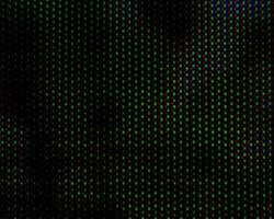 Patrón de fondo abstracto de puntos borrosos de colores sobre un fondo oscuro de cerca foto