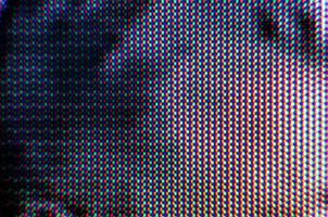 Patrón de fondo abstracto de puntos borrosos de colores sobre un fondo oscuro de cerca foto