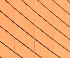 Architectural abstract pattern fragment of a wall of a yellow modern building photo