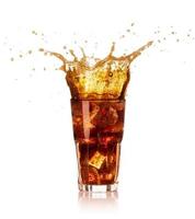 Glass of cola with big splash isolated on white background photo