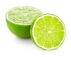 One half and slice of ripe lime isolated on white background