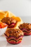 Pumpkin muffins on a white background. Trendy food, vegetable baking. Homemade cakes for a healthy diet. photo