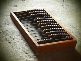 Old wooden abacus on a concrete surface
