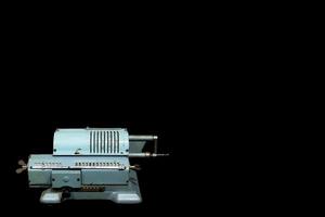 Vintage Soviet mechanical calculator isolated on black with empty copy space for text. photo