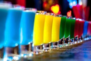 Colorful cocktails on a bar stand photo