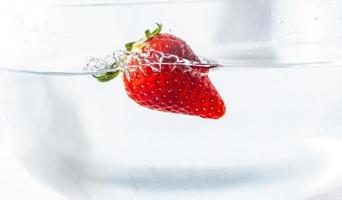 Strawberry floating in water photo