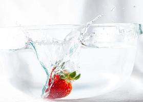 Strawberry splashing in water photo