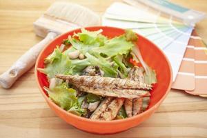 Grilled mackerel in a red bowl. photo