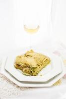 Pesto lasagna with white wine photo