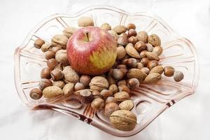 Walnuts and hazelnuts on a glass plate photo