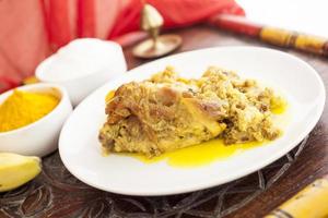 Chicken with turmeric, banana and coconut photo