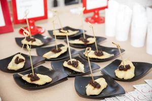 Appetizers on black plates photo