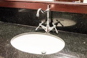 Faucet water sink in bathroom photo