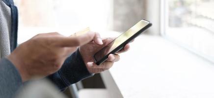 Person paying with a credit card on a phone photo