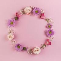 Blank circular frame made with pink flowers photo