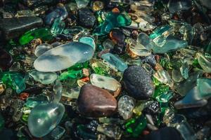 Close-up of colorful sea glass on sand in Vladivostok, Russia photo