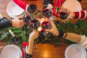Christmas dinner concept with top view wine glass cheers
