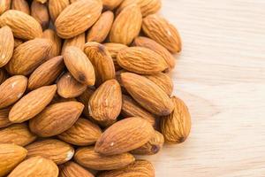 Almond on wooden background photo