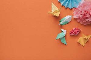 High angle view of origami paper art on orange background photo