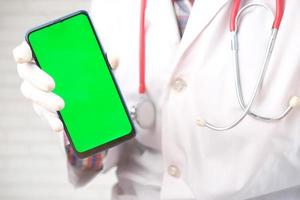 Doctor holding a phone mock-up photo