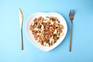 Mixed nuts on heart-shaped plate photo