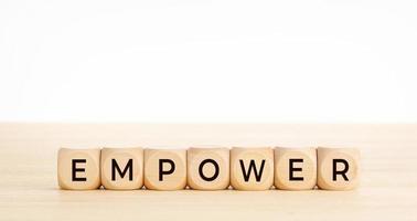 EMPOWER word on wooden blocks on wood table photo