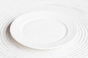 White plate on white wood background photo