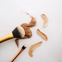 Brushes near makeup powder and concealer. High quality and resolution beautiful photo concept