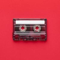 Flat lay minimalist vintage cassette tape on red background