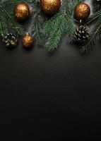 Christmas composition with green fir tree branches with gold baubles