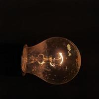 Old lightbulb in the dark photo