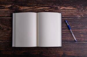 Empty notebooks and pens placed on the desk photo