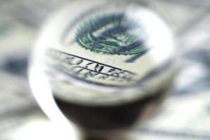 Abstract image of dollar banknotes seen through the lens ball. photo