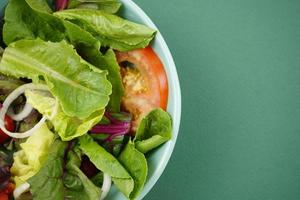Vegetable salad on green background. photo