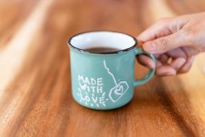 Cup of brewed black coffe on the wooden table photo