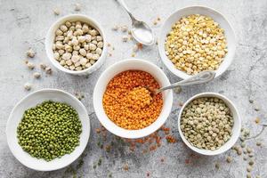 Bowls with different types of legumes photo