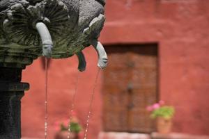 Fountain and red facade in Peru photo