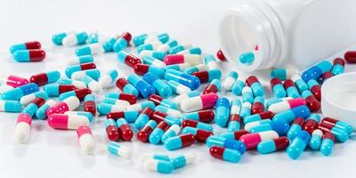 Many type of medical drugs pills capsules on white background photo