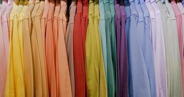 Close up of multi colored shirts on hangers photo