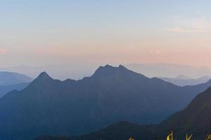 High angle viewpoint sunset over mountains and forest photo