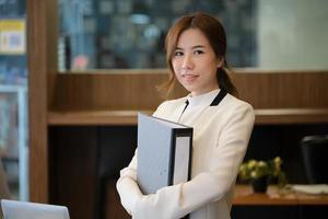 Businesswoman holding a binder photo